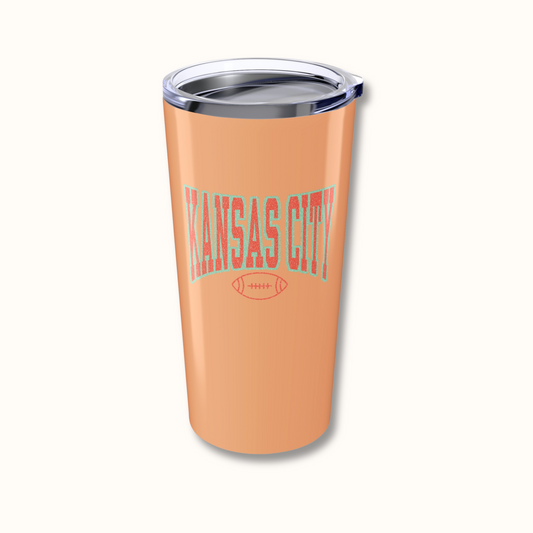 Orange tumbler with 'Kansas City' text on a white background