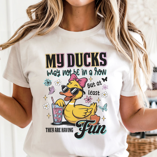 Person wearing a white t-shirt with a cartoon duck design and text.