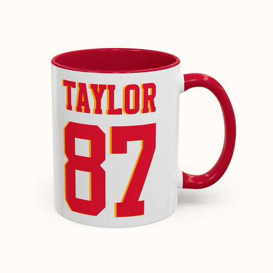 White mug with red interior and handle, featuring the name 'Taylor' and number '87' in red and yellow.