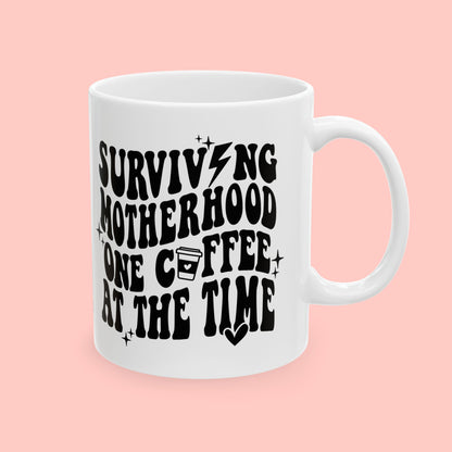 SURVIVING MOTHERHOOD ONE COFFEE AT A TIME - CERAMIC MUG