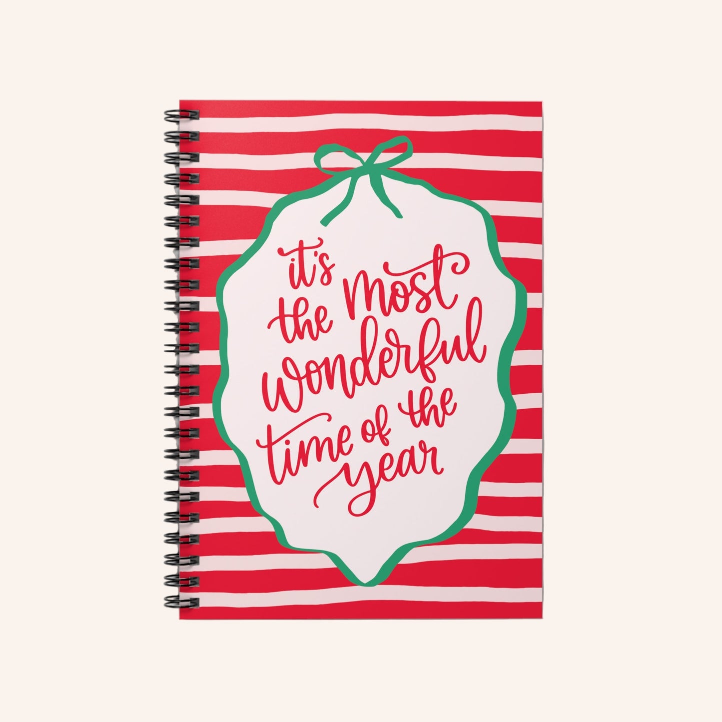 Notebook with red and white striped cover and 'it's the most wonderful time of the year' text.