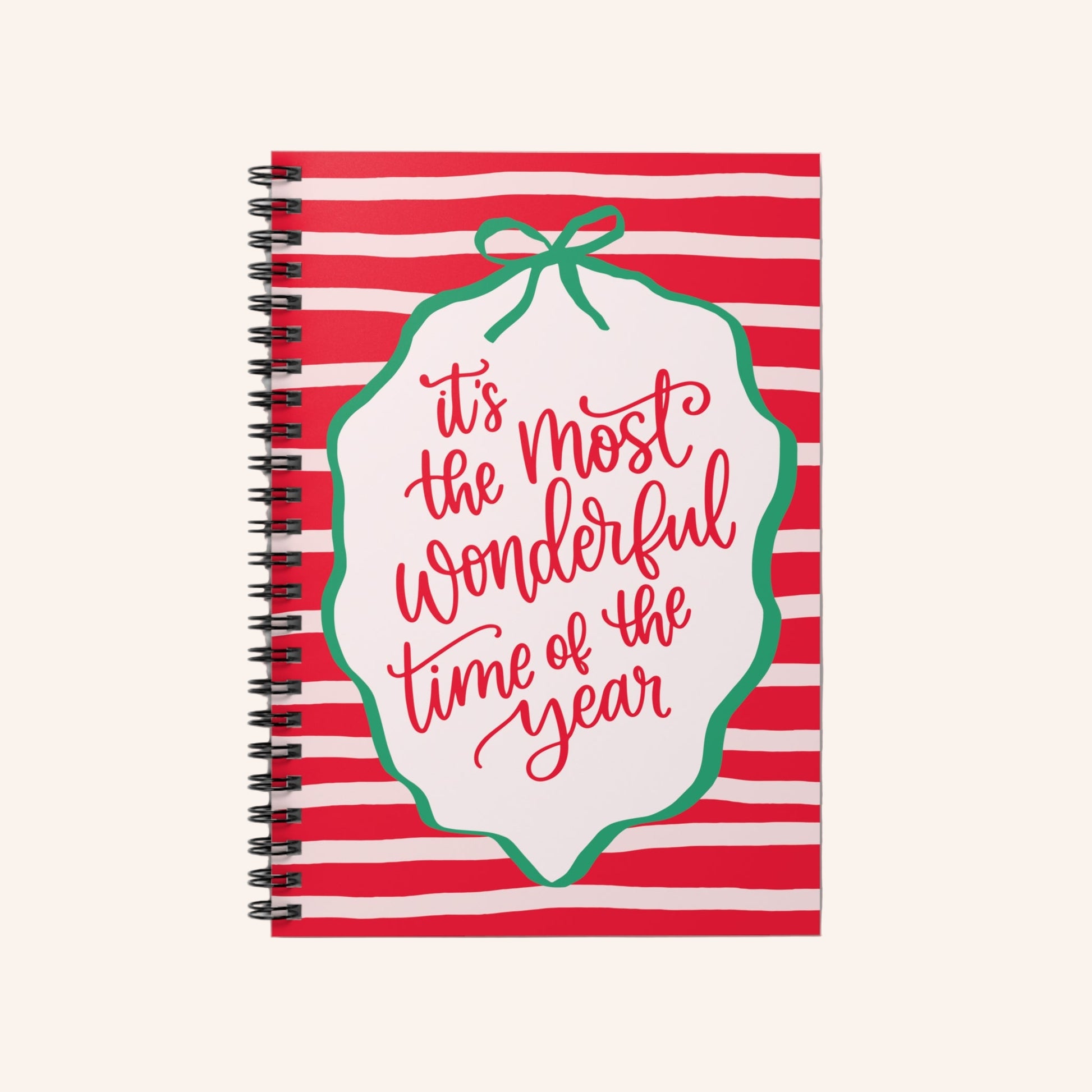 Notebook with red and white striped cover and 'it's the most wonderful time of the year' text.
