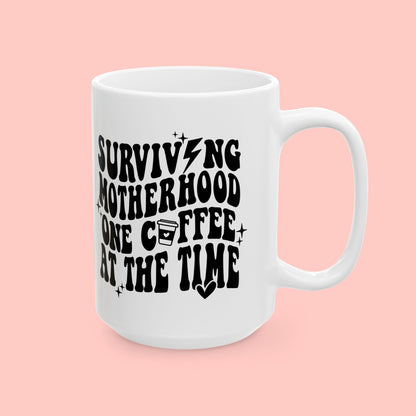 SURVIVING MOTHERHOOD ONE COFFEE AT A TIME - CERAMIC MUG