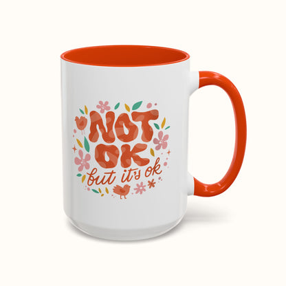 Mug with 'Not OK but it's OK' text and floral design on a white background