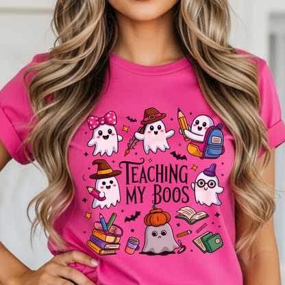 Person wearing a pink t-shirt with Halloween-themed TEACHER graphics and text.
