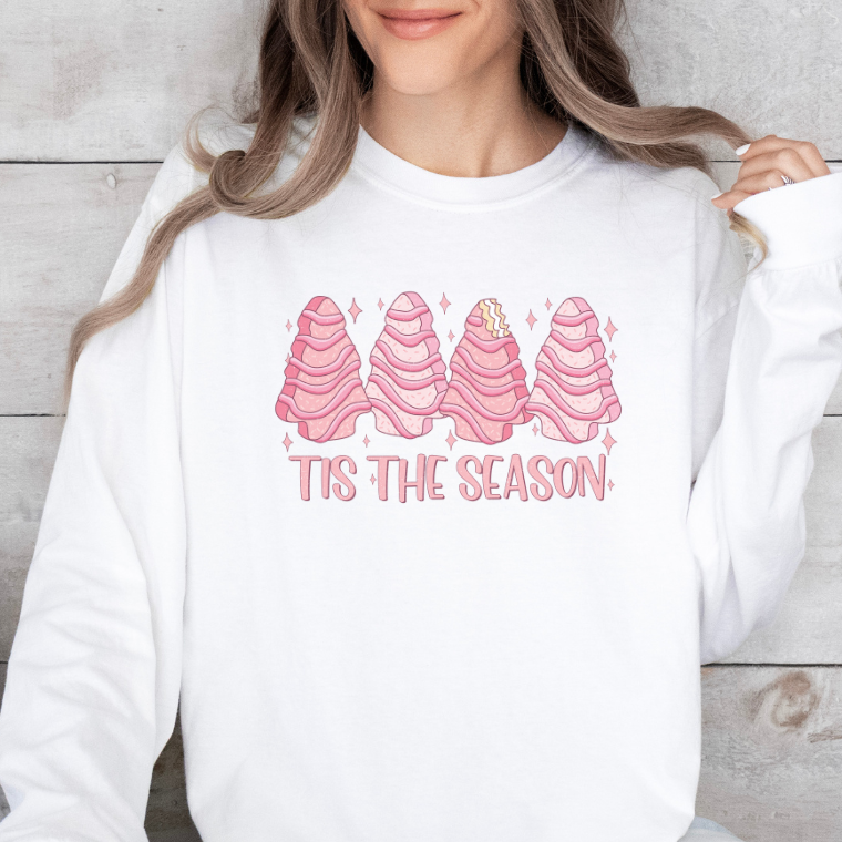 Person wearing a white sweatshirt with pink ice cream cones and 'Tis the Season text.