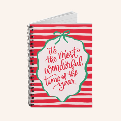 Notebook with red and white striped cover and 'it's the most wonderful time of the year' text.