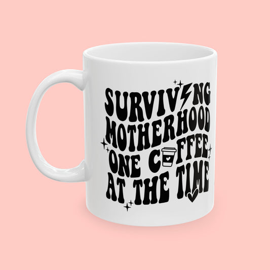 SURVIVING MOTHERHOOD ONE COFFEE AT A TIME - CERAMIC MUG