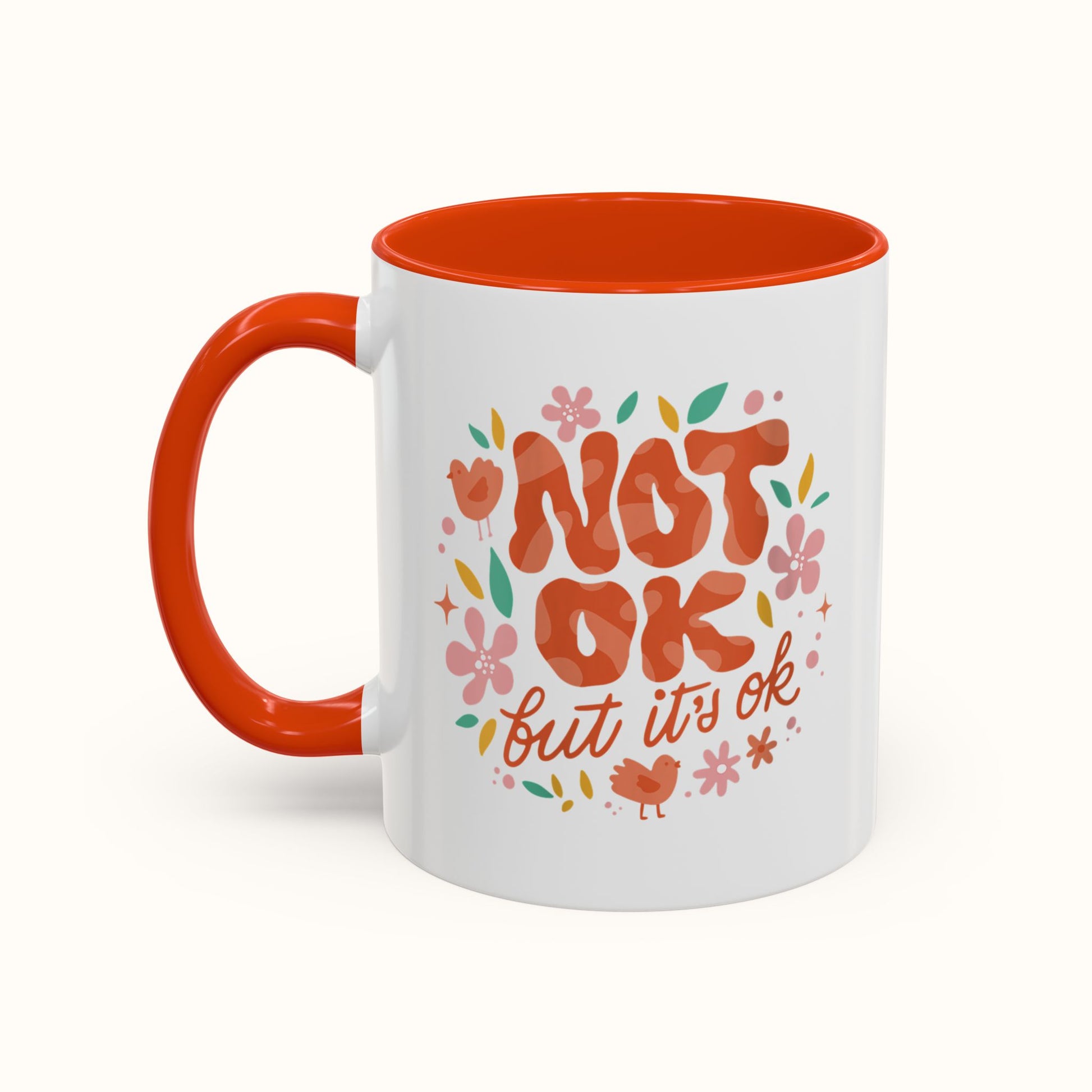 White mug with orange interior and handle, featuring decorative text and illustrations on a white background.